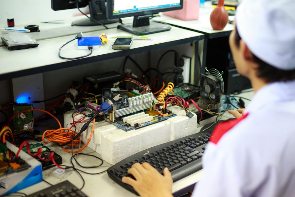 Technician assembling a computer workstation