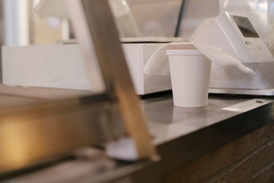 Fresh cup of coffee served at a convenience store counter