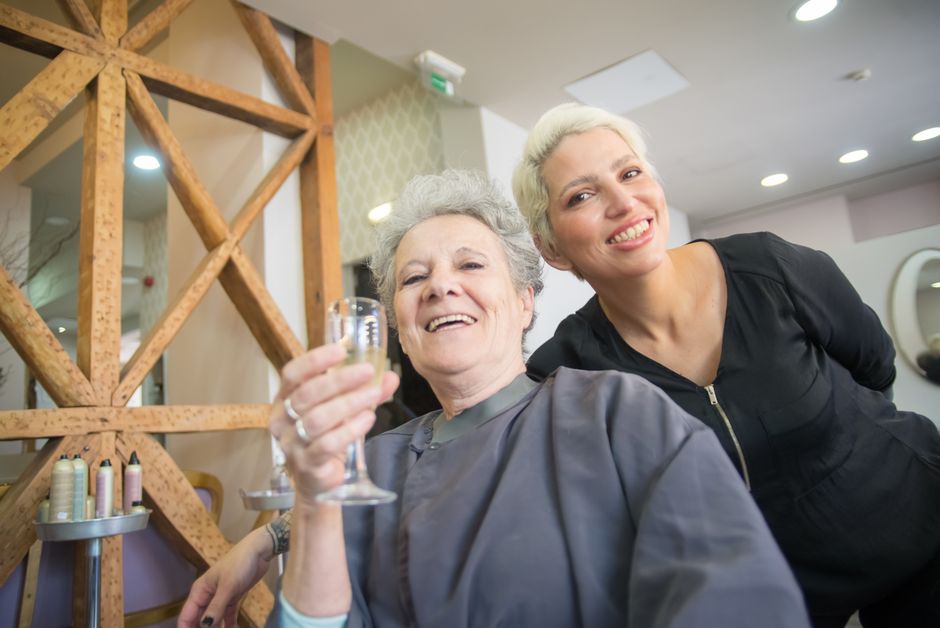 The interior of a beauty salon with staff attending to clients.