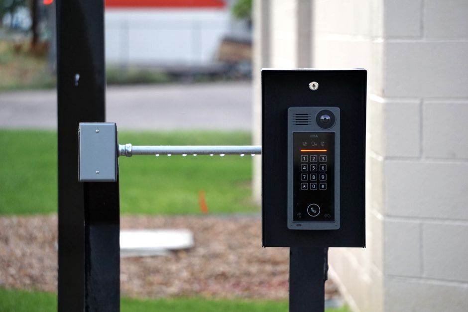 A door entry intercom system installed at the entrance to an office.