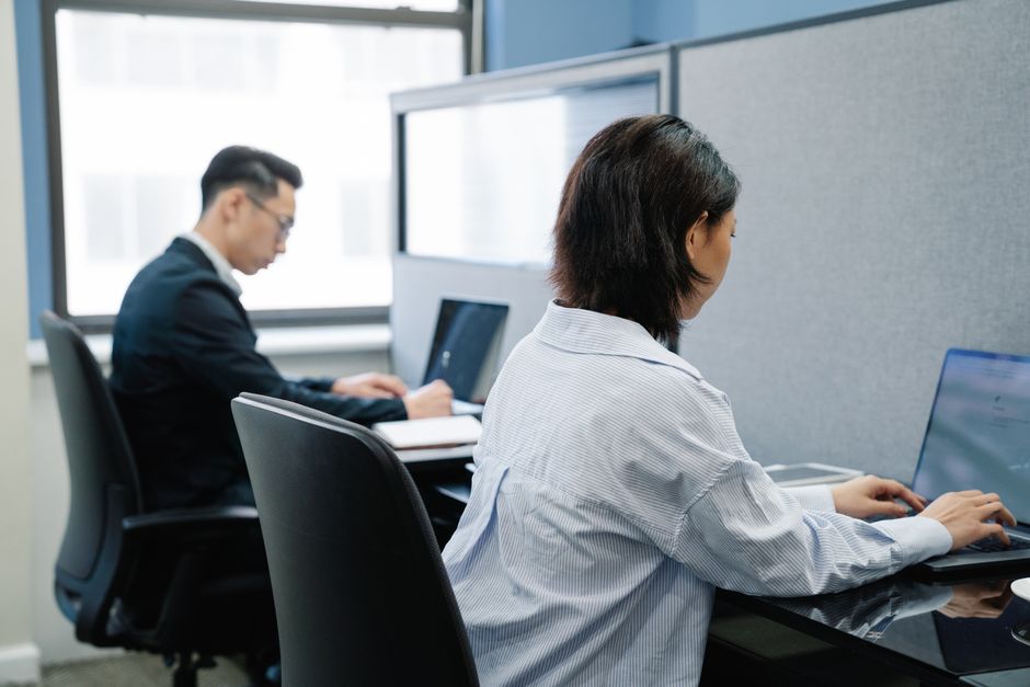 People collaborating with cloud computing solutions on laptops