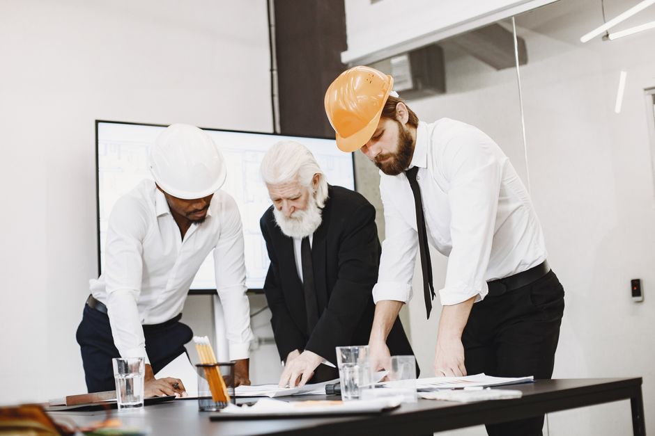 Construction managers reviewing plans on a building site