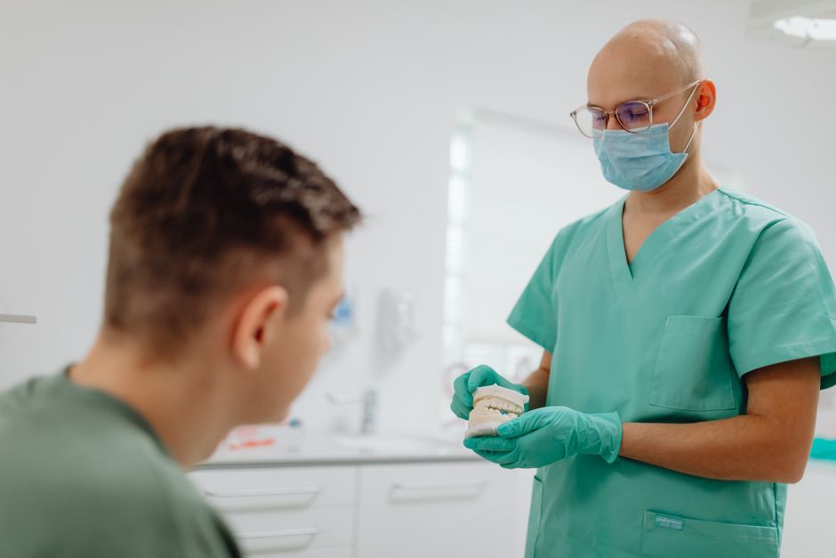 Dentist consulting patient in modern dental office