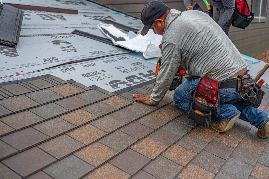 Technician repairing a leak on a commercial roof
