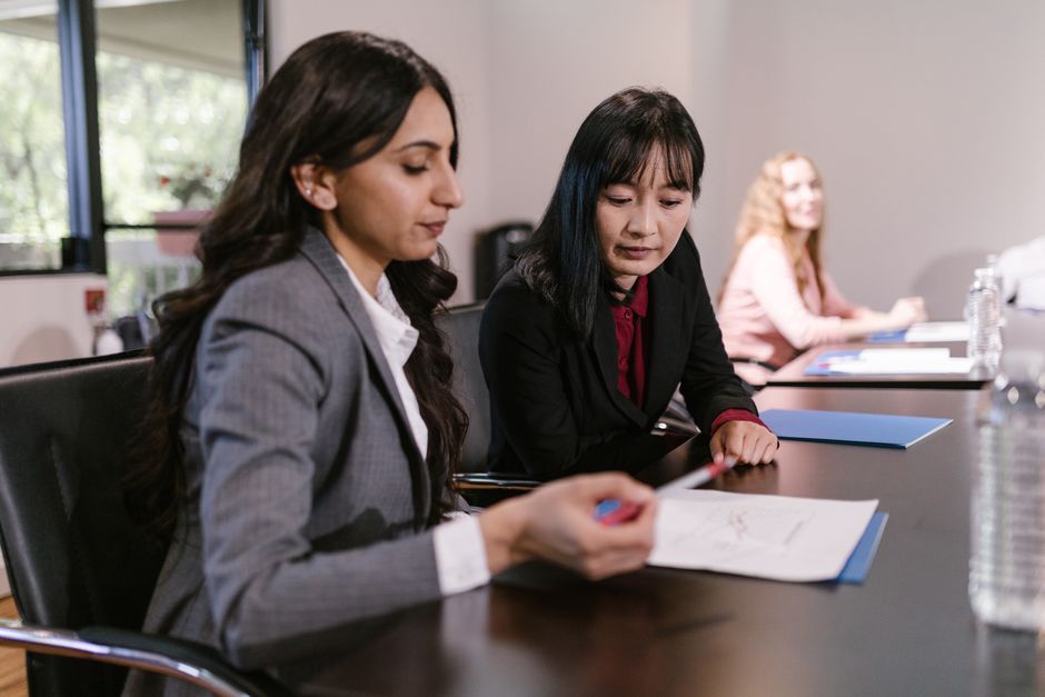 Team reviewing workflow documents in an office meeting room