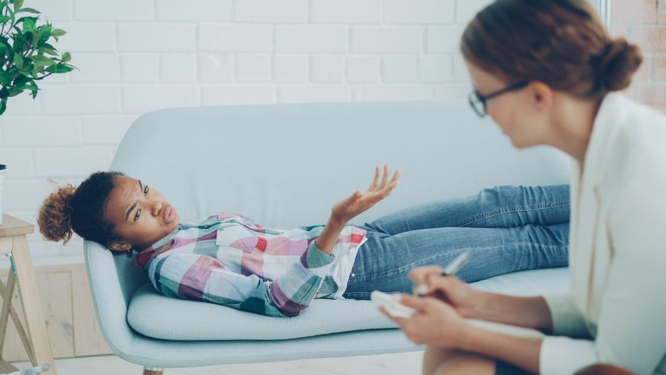 Clinical psychologist supporting a client during CBT session