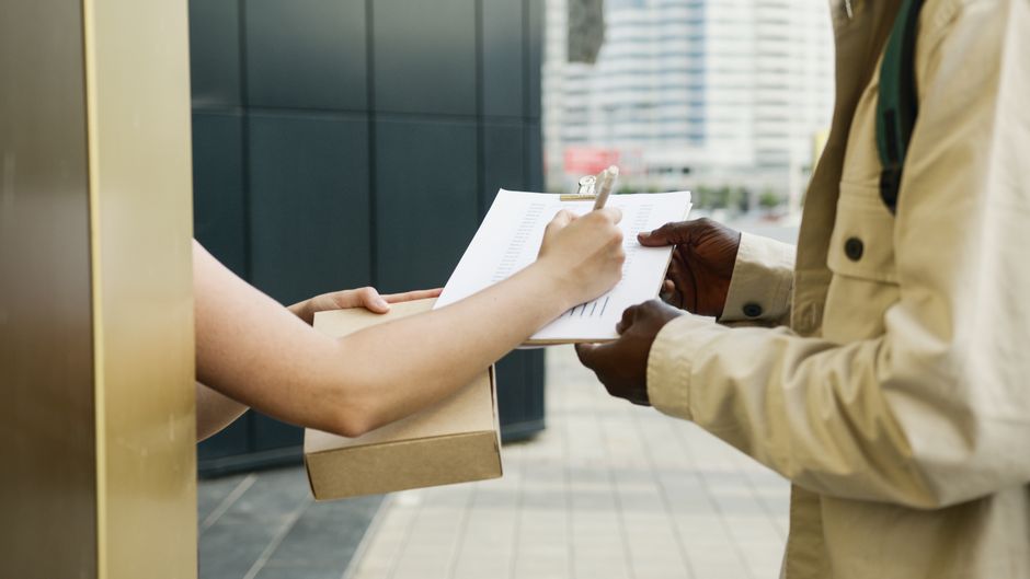 A courier handing over parcels for delivery