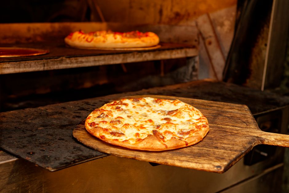 Artisan pizza being baked in a restaurant oven