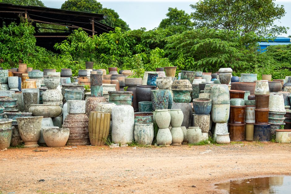 Decorative ceramic pots and containers arranged outside in a garden center.