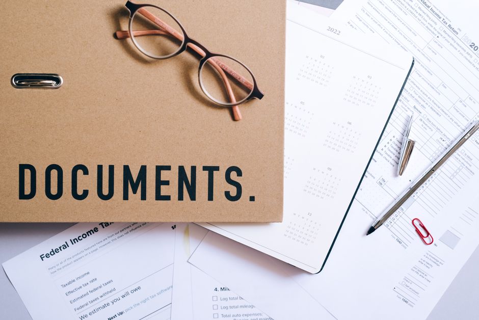 Estate planning documents on desk with pen and folder