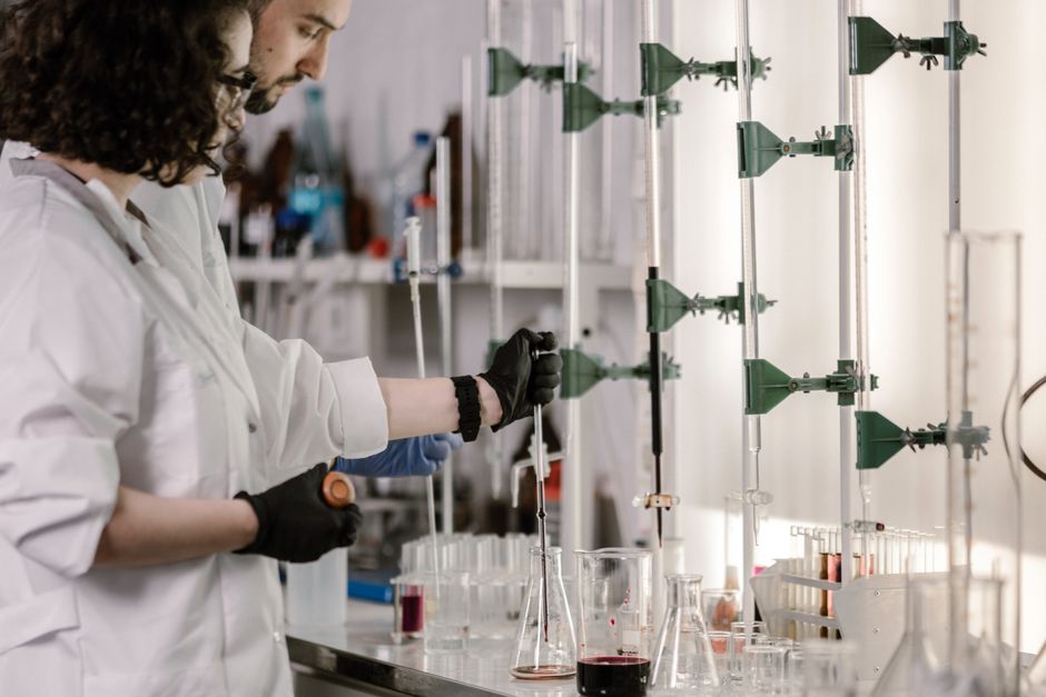 Modern supplement research laboratory with specialized equipment and scientists