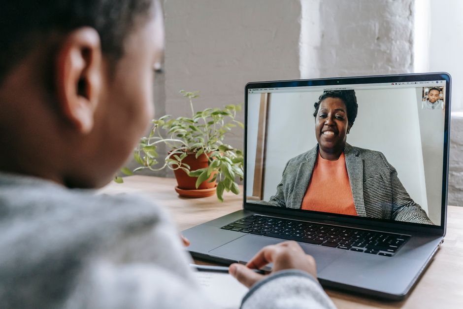Student using a laptop for online counseling session at home