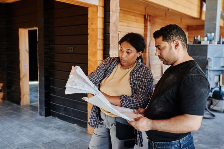 Contractor examining blueprints and house plans
