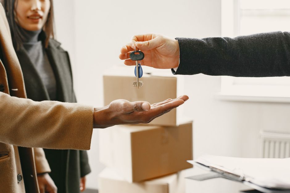 Key handover symbolizing letting and leasing services