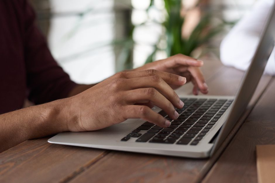 Person checking digital newsletter on a laptop