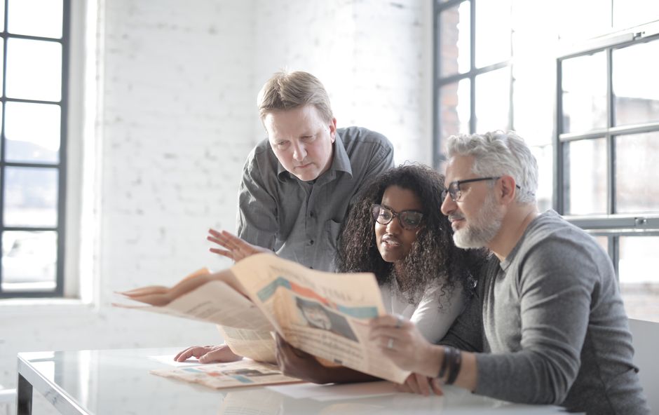 Team discussing local newspaper advertising opportunities