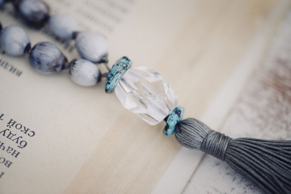 A collection of handmade bookish jewelry and crafts on display.