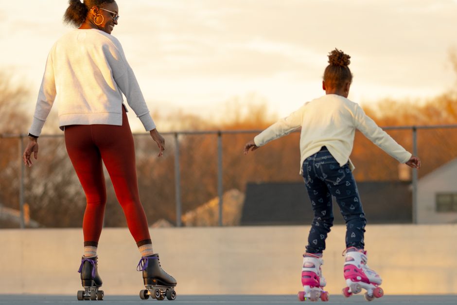 Families roller skating together indoors